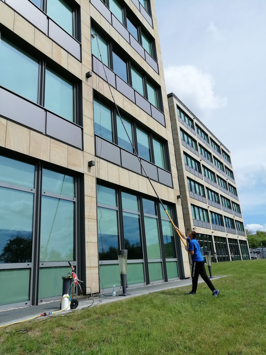 Mycie fasady biurowca tyczką teleskopową